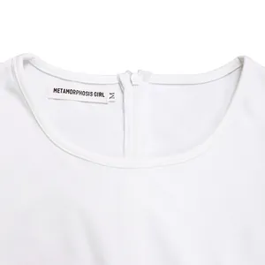Detailed view of white dress round neckline with zipper and Metamorphosis Girl label