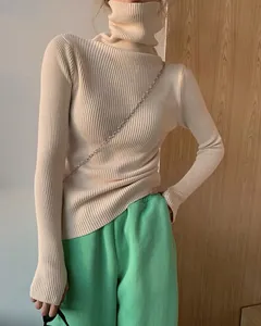 Close-up detail of a soft beige slim fit turtleneck ribbed sweater for women's fashion
