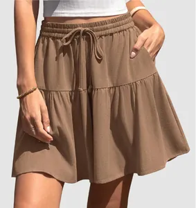 Detailed view of a brown drawstring tiered mini skirt with elastic waist and pockets
