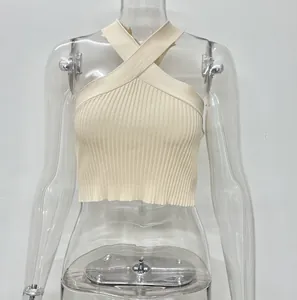 Detail of beige ribbed knit crop top featuring a stylish cross halter neck design