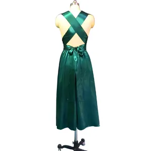Back view of emerald green satin multi-way dress with criss-cross straps and waist tie