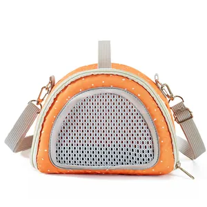 Detail view of orange polka dot small pet carrier bag with mesh window and grey strap