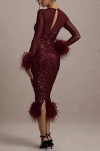 Detailed back view of a burgundy sequined party dress featuring mesh sleeves and feathers.