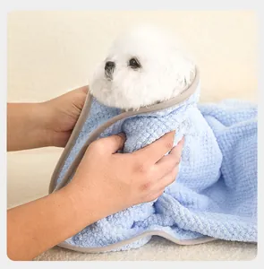 Close-up of a white dog wrapped in a blue plush quick-drying pet bath towel