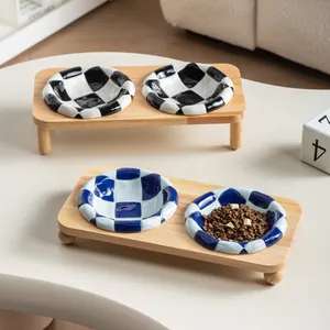 Elevated checkerboard ceramic double pet bowls with solid oak wood stand for cats and dogs.