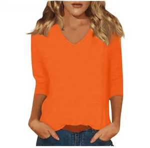 Detailed view of women's orange V-neck t-shirt showing comfortable fit and 3/4 sleeves