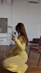 Detailed view of women's yellow hollow-out knitted set with elegant high-waist trousers