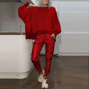 Casual women's red two-piece tracksuit with oversized side slit top and joggers.
