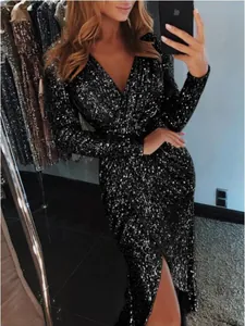 Close-up detail of a glamorous black sequined evening dress featuring a deep V-neck