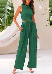 Model wearing a dark green 2-piece knit set with sleeveless top and wide-leg pants