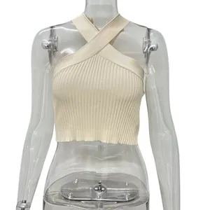 Close-up of beige ribbed knit halter crop top with criss-cross front detail