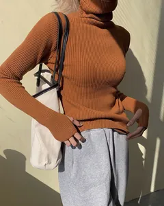 Slim fit burnt orange ribbed turtleneck sweater with unique thumbholes for a stylish look