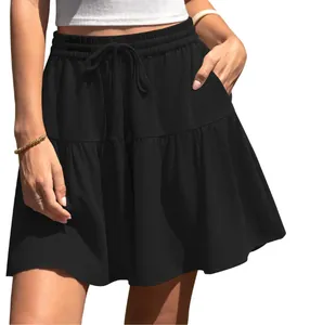 Close-up detail of women's black tiered mini skirt with drawstring waist and pockets