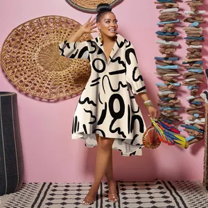 Full length view of a women's long sleeve shirt dress with bold black abstract patterns
