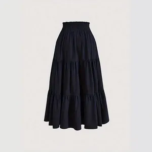 Plus size black tiered maxi cake skirt with high elastic waist on plain background