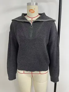 Close-up view of a grey quarter-zip knit sweater with ring pull on a mannequin