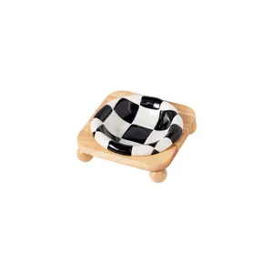 Creative black and white checkerboard ceramic pet bowl with a sturdy natural oak wooden stand