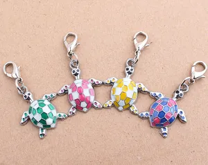 Detail of turtle-shaped metal charms with lobster clasps in multiple vibrant enamel colors.