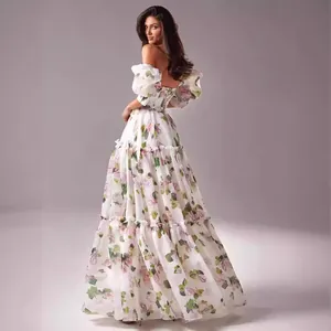 Elegant off-the-shoulder white organza maxi dress with floral print and puff sleeves