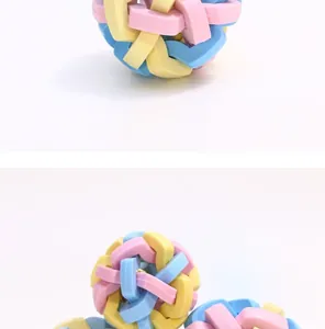 Macro view of a durable TPR dog bell ball with colorful pastel interlocking rings.