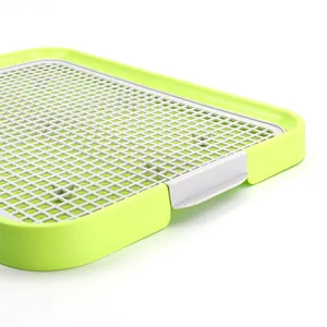 Large pet dog toilet featuring a grey non-slip grid and bright green plastic frame