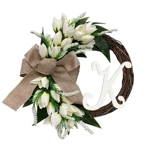 Close-up detail of monogram tulip wreath featuring a burlap bow and white letter K decoration