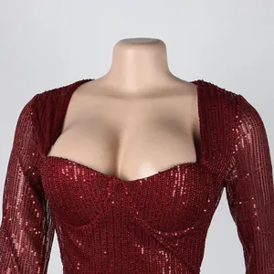 Close-up detail of a sparkling burgundy red sequin bodycon dress featuring a elegant square neckline