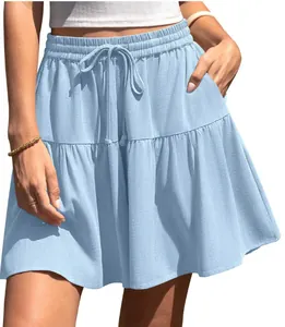 Detailed view of a light blue tiered mini skirt featuring a drawstring waist and side pockets