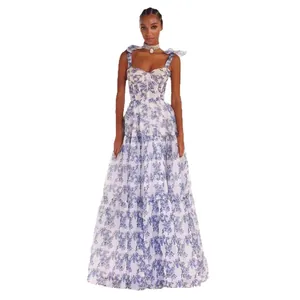 Elegant blue floral organza tiered maxi dress with shoulder tie bows for summer fashion.