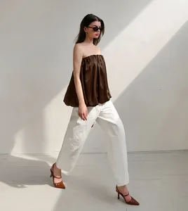 Mannequin marchant en haut bustier bouffant en satin marron et pantalon blanc large