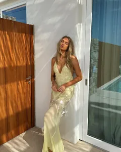 Elegant yellow V-neck mermaid maxi dress with sequin details and backless design
