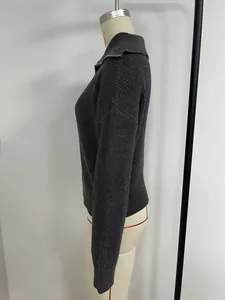 Side profile view of a vintage dark grey knit sweater with a zip-up V-neck collar detail.