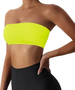 Detail view of a vibrant neon yellow strapless sports tube top worn by a model