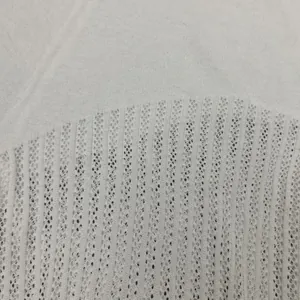 Close-up of white pointelle knit fabric texture for summer women's see-through set