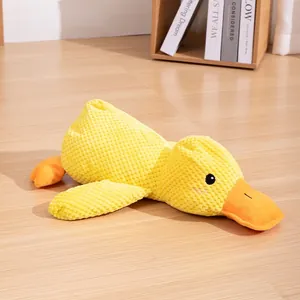 Detailed view of yellow plush duck dog toy with textured corduroy fabric on wood floor