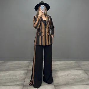 Detailed view of elegant brown and black striped blazer with matching wide-leg trousers.