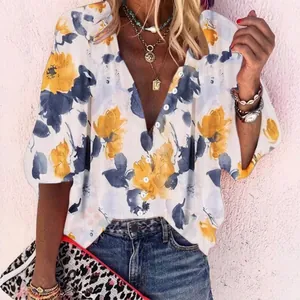 Detailed view of women's floral print V-neck blouse with decorative buttons for summer