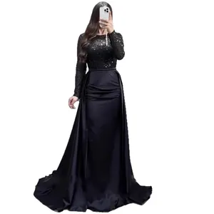 Elegant black long-sleeved evening gown with sequined top and satin skirt for formal events.