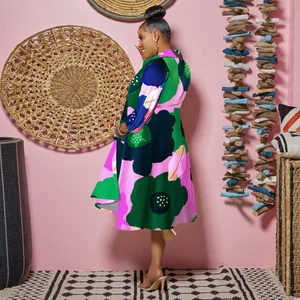 Detail of a vibrant floral V-neck dress with long sleeves in a lifestyle setting.