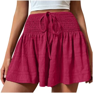 Close-up of magenta high-waisted drawstring shorts with smocked waistband detail