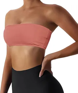 Detailed macro shot of a coral orange strapless sports bra featuring a soft ribbed fabric