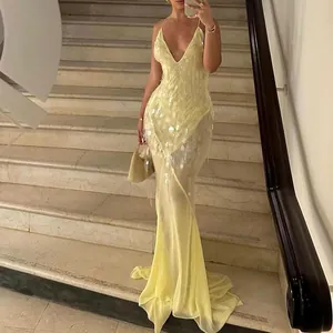 Elegant pale yellow V-neck sequined mermaid evening gown featuring a sexy backless design