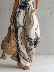 Detail of a women's digital print sleeveless jumpsuit with wide legs and abstract pattern