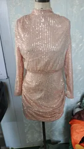 Elegant rose gold sequined mini dress featuring long sleeves and a mock neck design