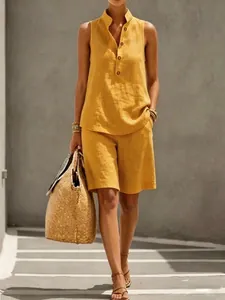 Mustard yellow linen-blend two-piece set with sleeveless buttoned top and shorts