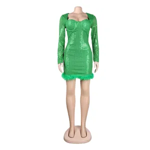 Close-up of sexy green sequin mini dress featuring long sleeves and green feather trim.