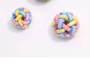 Close-up of colorful TPR woven dog toy balls with internal bells for molar cleaning