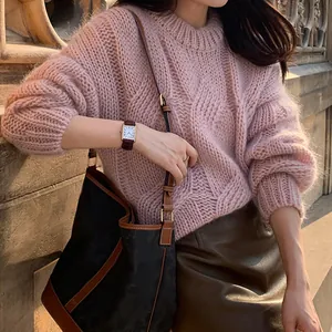 Detailed close-up showing texture of a pink chunky cable knit sweater for women