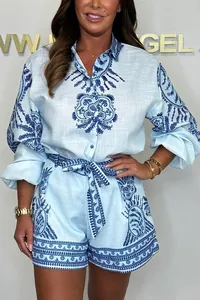 Detailed view of women's blue printed two-piece set featuring long sleeve shirt and shorts