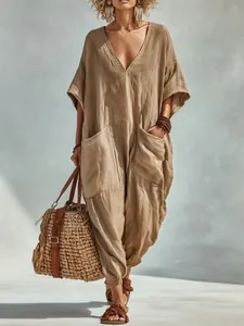 Boho khaki linen-blend V-neck jumpsuit with oversized pockets for summer beach vacations.